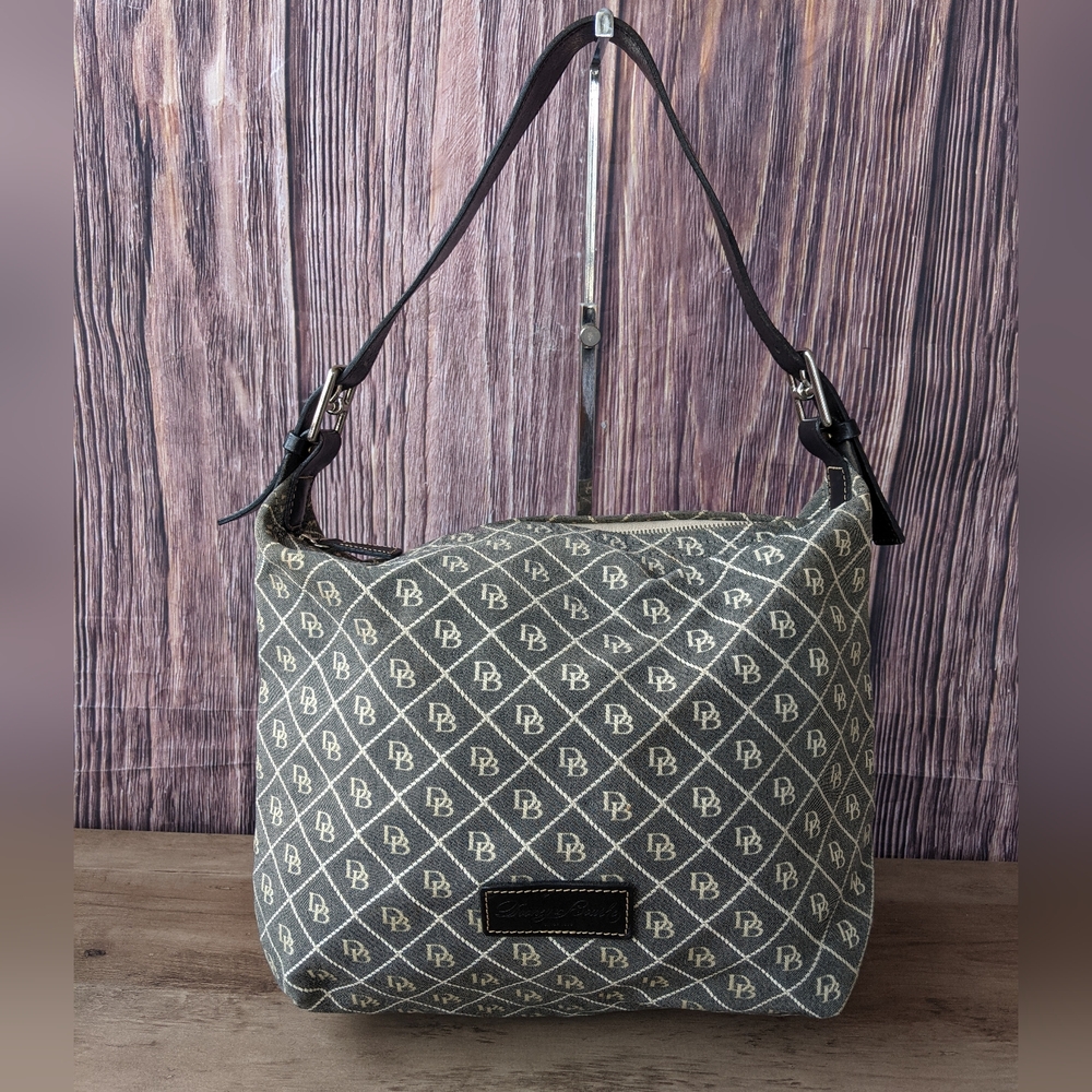 Dooney & Bourke shoulder bag featuring the brand's classic "DB" monogram pattern